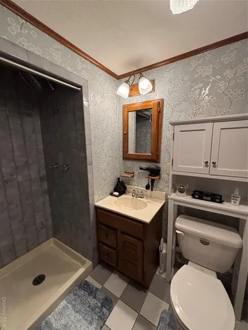 a bathroom with a sink toilet vanity and tub