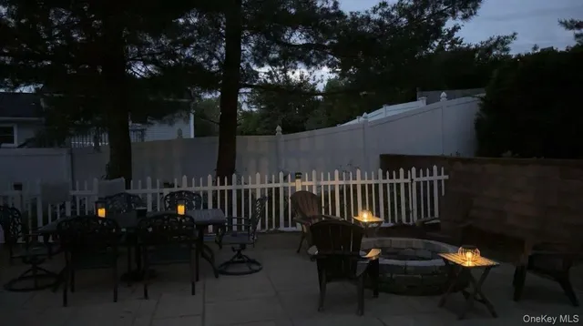 a view of a patio with a table and chairs and a fire pit