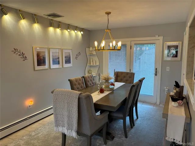 a view of a dining room with furniture and chandelier