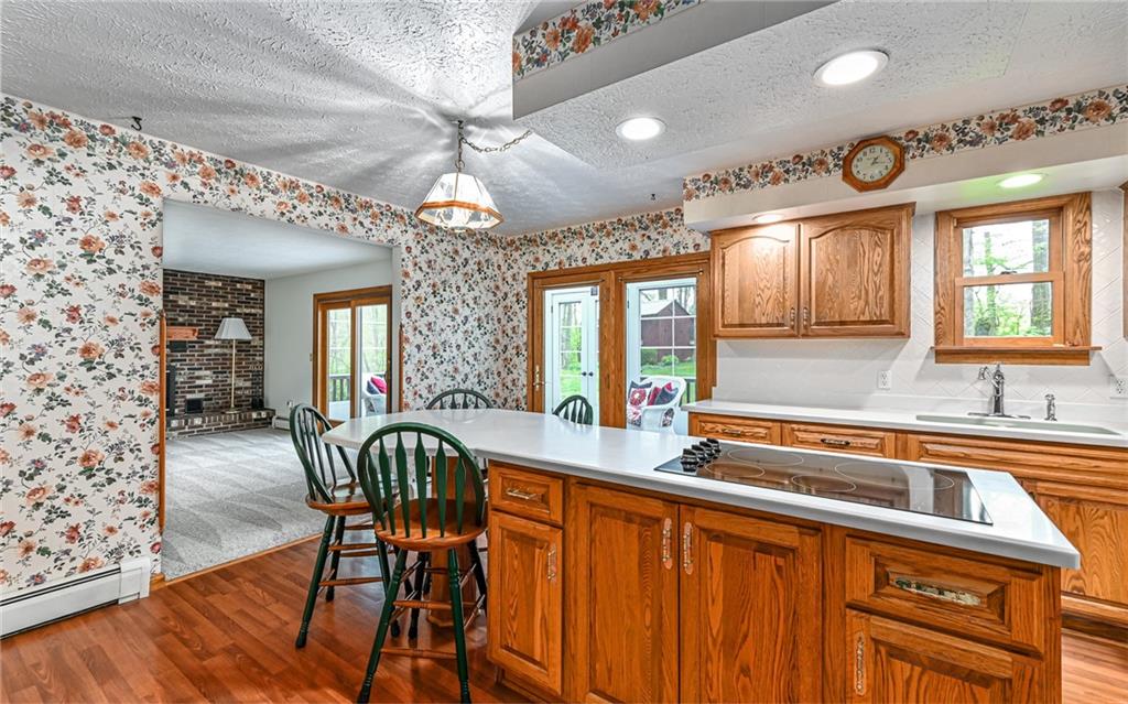230 Election House Road Butler, PA 16001 - Photo 11 of 38 a kitchen that has a table chairs in it and wooden floors