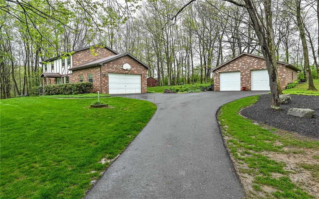 230 Election House Road Butler, PA 16001 - Photo 3 of 38 a front view of a house with a yard and large trees