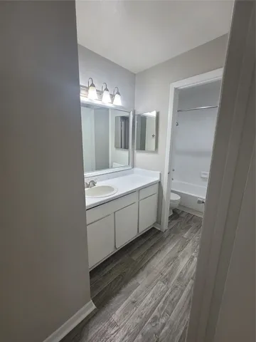 a bathroom with a sink a toilet and mirror