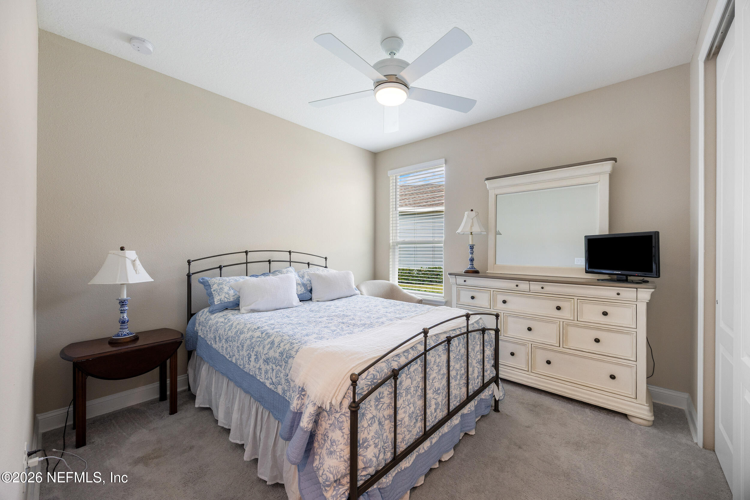 311 Dosel Lane St. Augustine, FL 32095 - Photo 23 of 37 a bedroom with a bed a couch and a flat screen tv