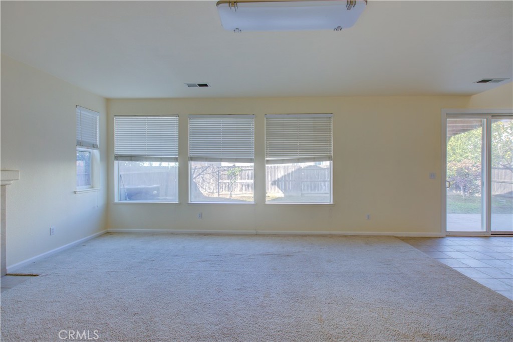 4651 Stern Drive Merced, CA 95348 - Photo 13 of 38 an empty room with wooden floor and windows
