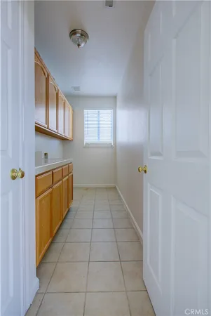 a kitchen with cabinets and window