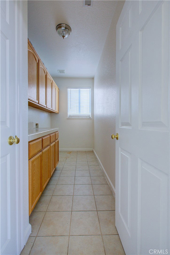 4651 Stern Drive Merced, CA 95348 - Photo 15 of 38 a kitchen with cabinets and window