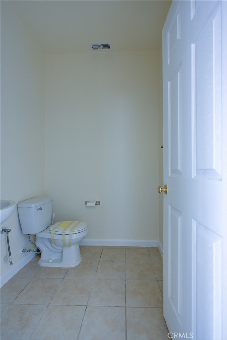 4651 Stern Drive Merced, CA 95348 - Photo 16 of 38 a white toilet sitting next to a white cabinet