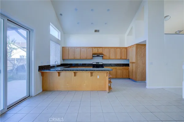 a kitchen with granite countertop a sink and a cabinets