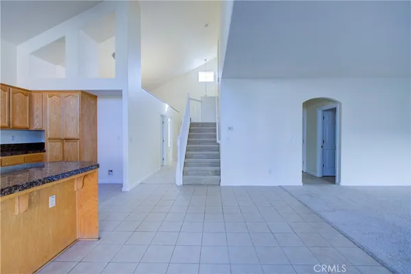 a view of a kitchen with stairs and an empty room