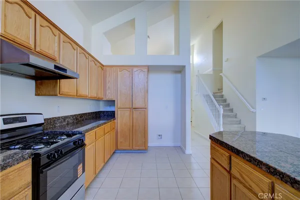a kitchen with granite countertop a stove and a cabinets