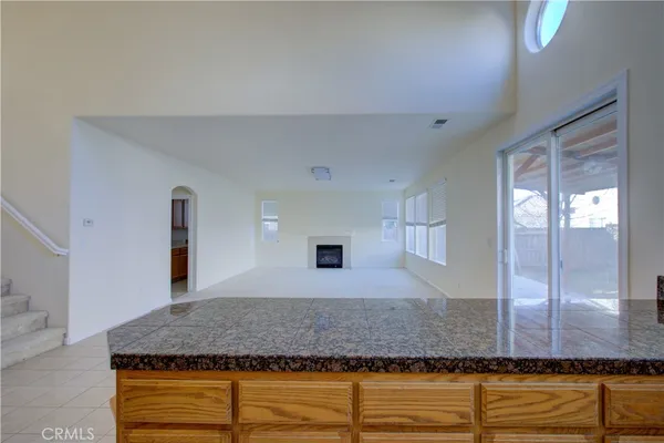 a bathroom with a granite countertop sink and mirror