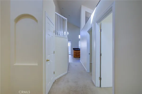 a view of a hallway with entryway door