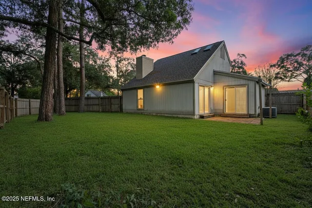 a front view of house with yard and green space