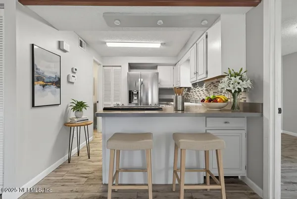 a hallway with a dining table and chairs