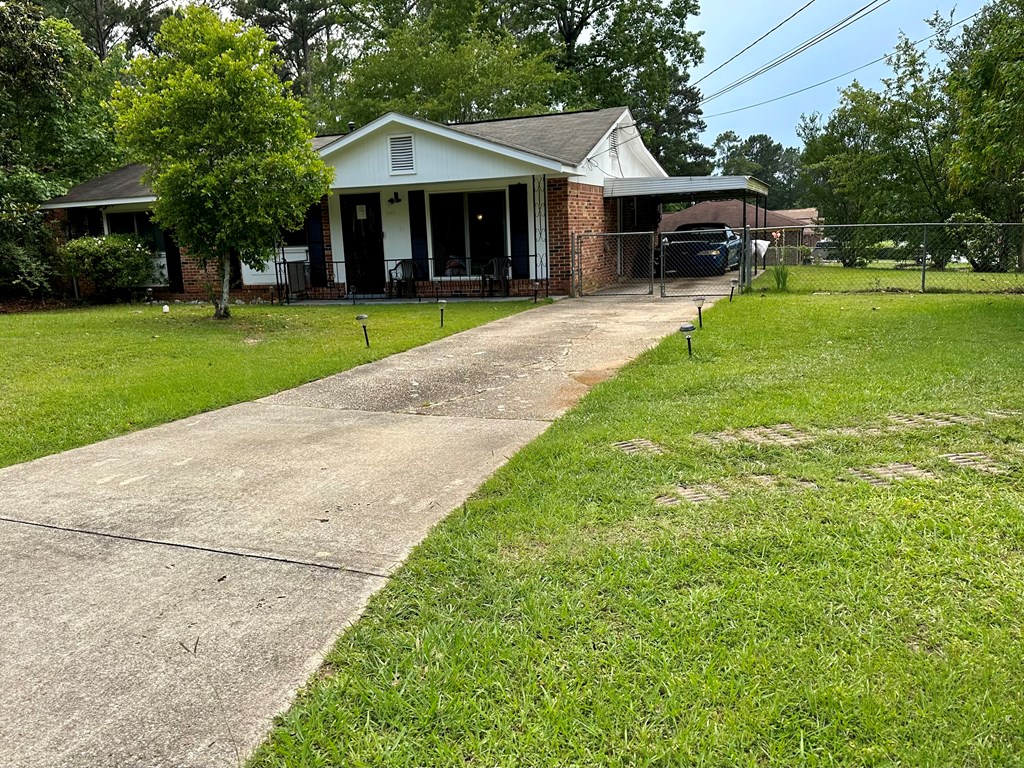 3245 Doyle Avenue Columbus, GA 31907 - Photo 14 of 21 a front view of a house with a garden and trees