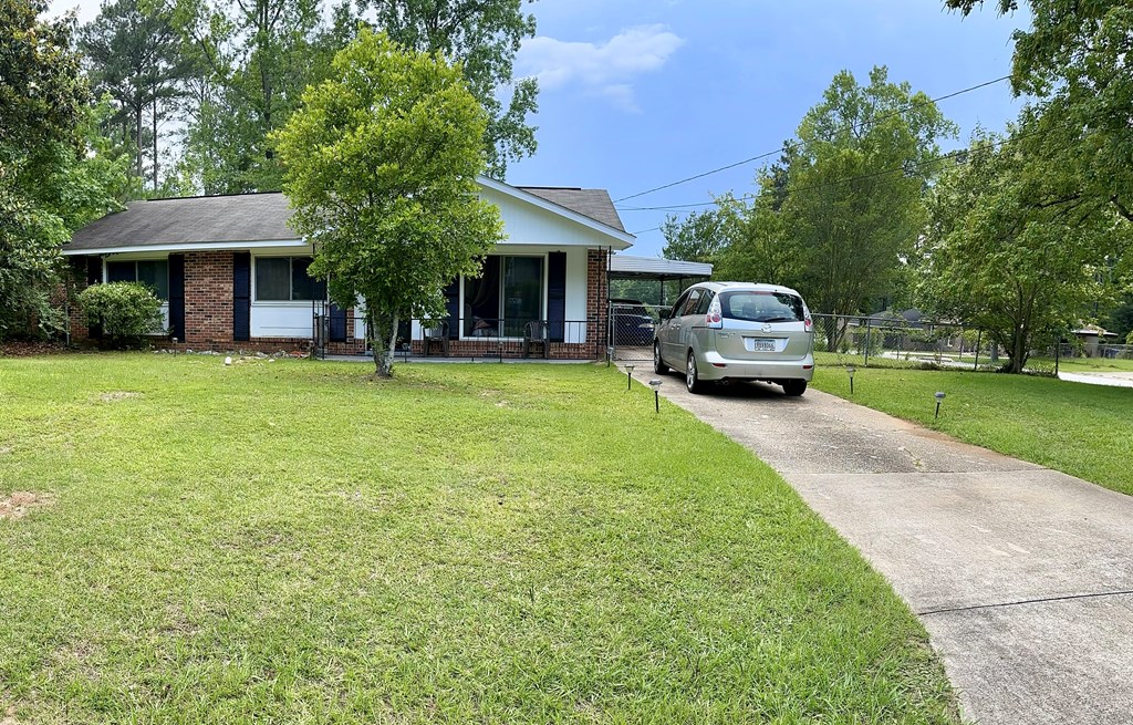 3245 Doyle Avenue Columbus, GA 31907 - Photo 16 of 21 a front view of a house with a garden and trees