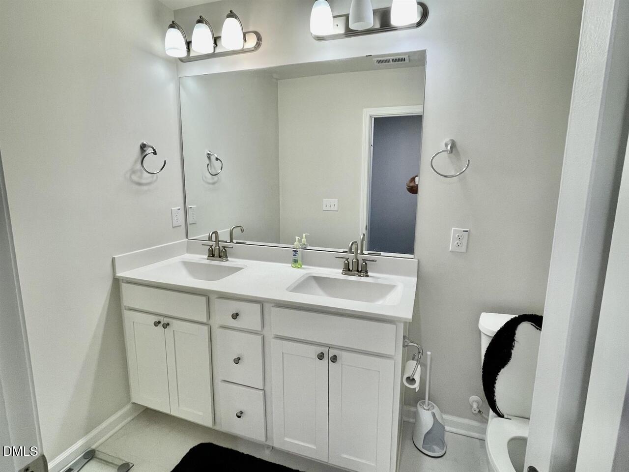 1807 Wrenn Road Durham, NC 27703 - Photo 36 of 43 a bathroom with a double vanity sink and mirror