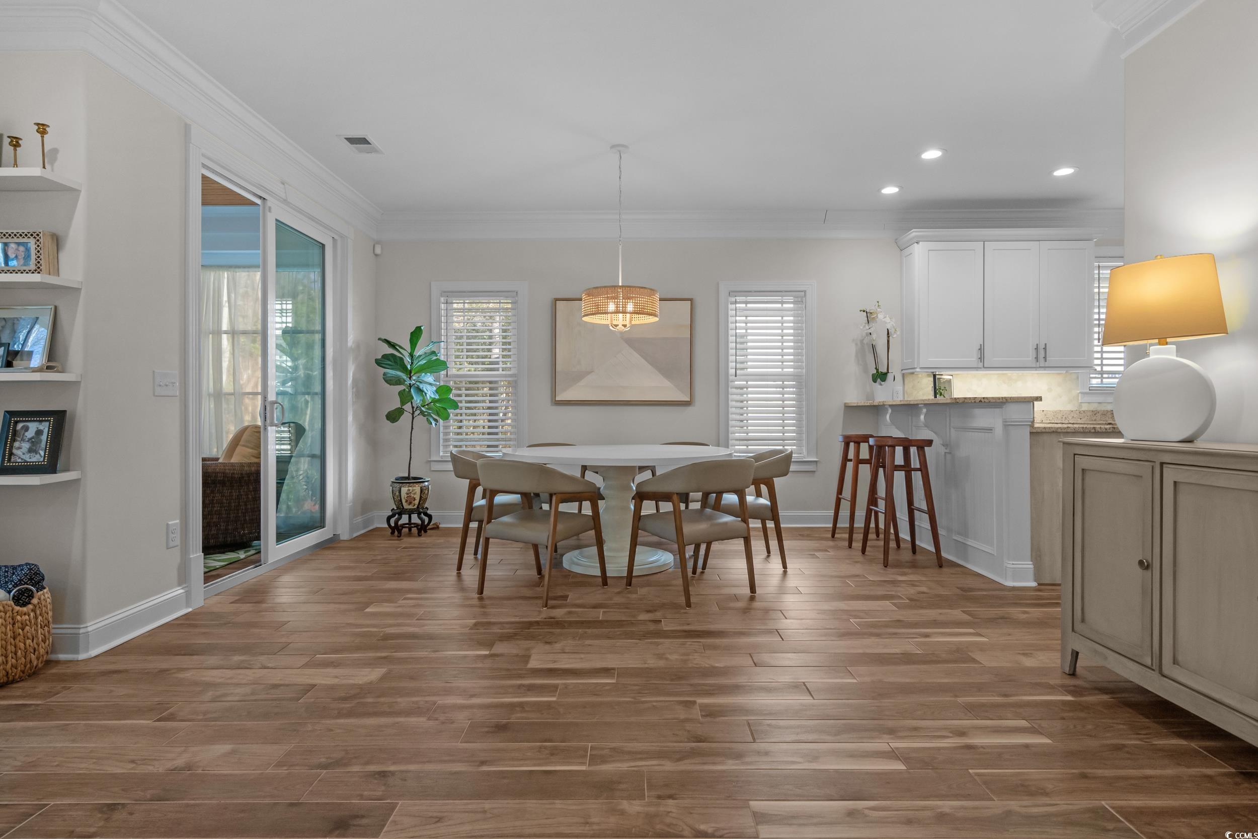 3021 Moss Bridge Lane Myrtle Beach, SC 29579 - Photo 12 of 40 Dining space featuring ornamental molding, wood finish floors, and recessed lighting