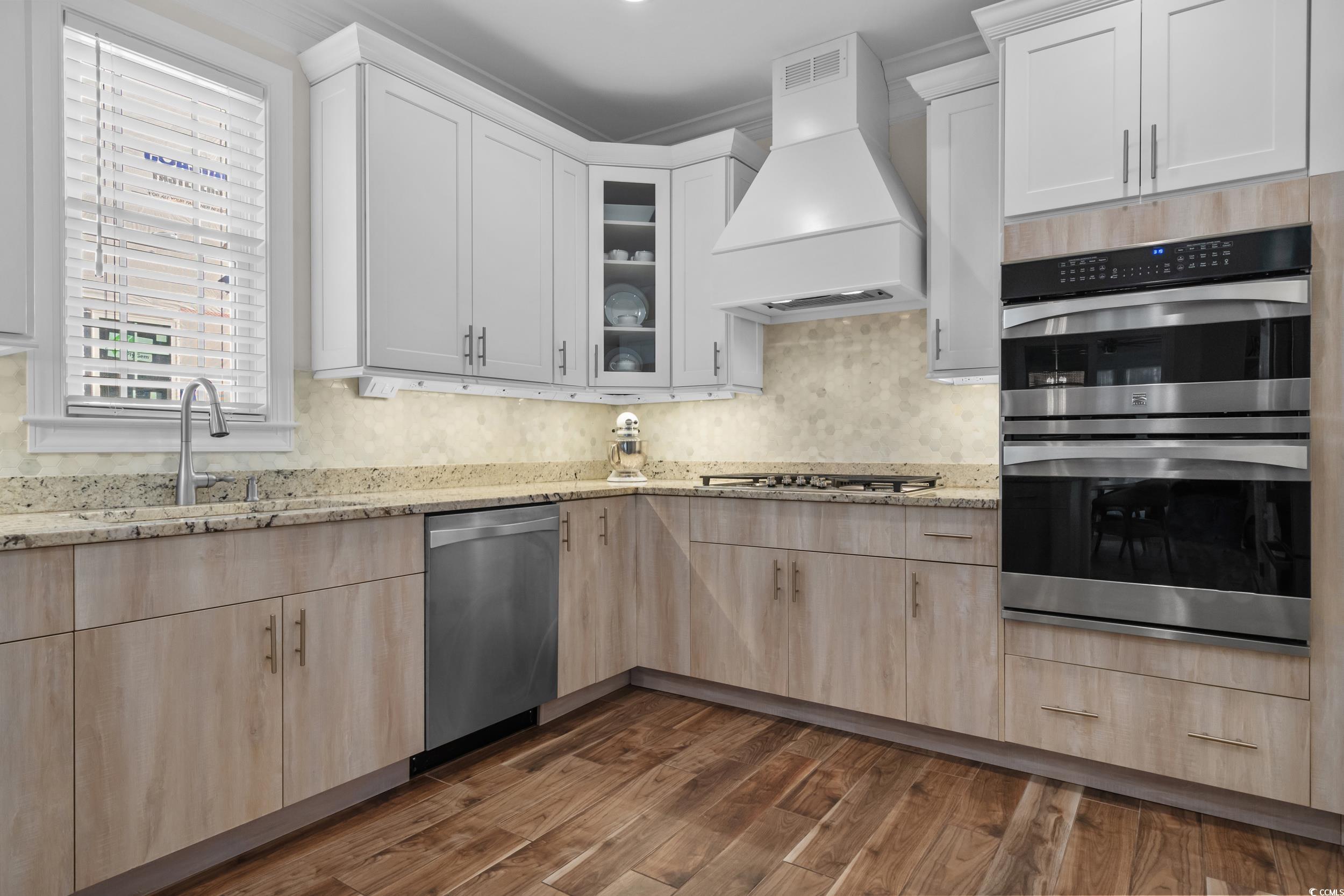 3021 Moss Bridge Lane Myrtle Beach, SC 29579 - Photo 13 of 40 Kitchen featuring stainless steel appliances, custom exhaust hood, light stone countertops, and light brown cabinets