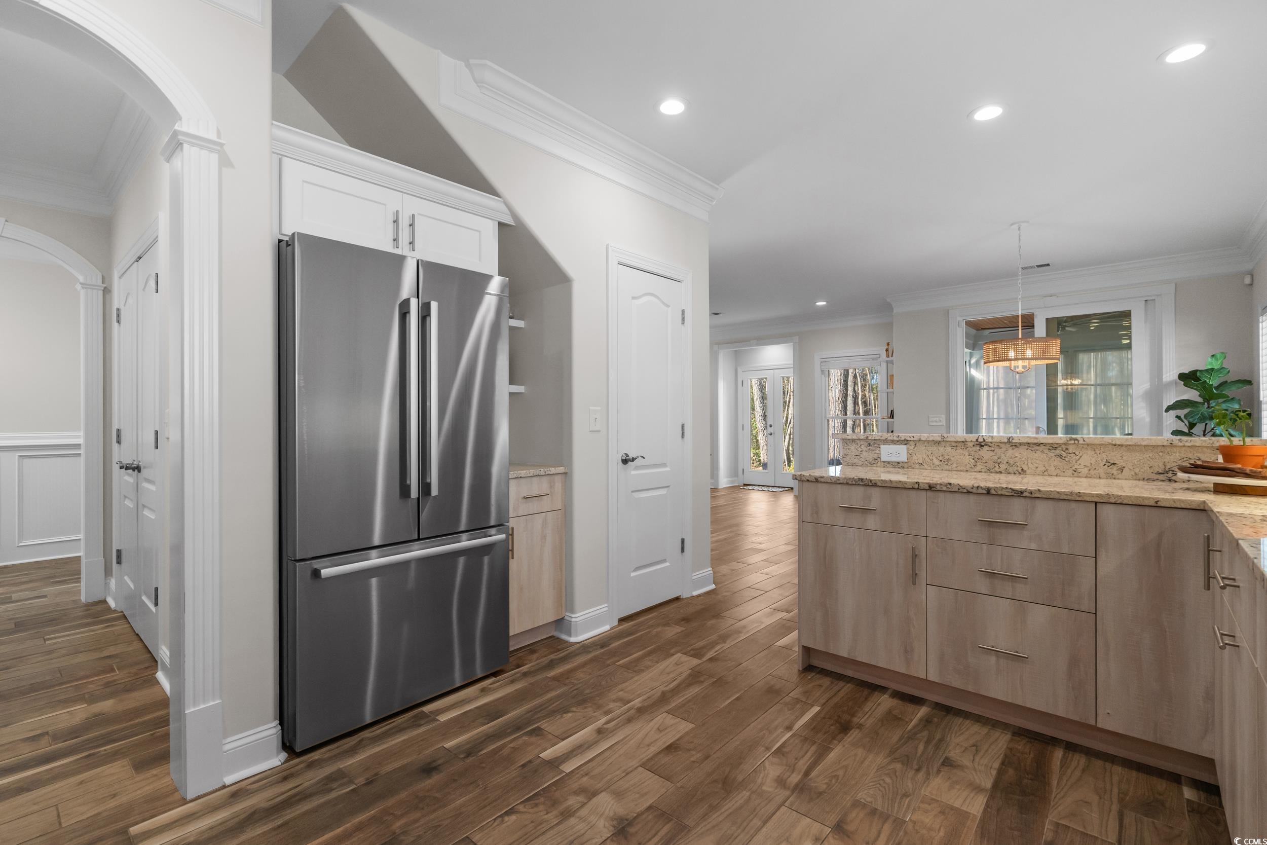 3021 Moss Bridge Lane Myrtle Beach, SC 29579 - Photo 17 of 40 Kitchen with freestanding refrigerator, crown molding, arched walkways, hanging light fixtures, and recessed lighting