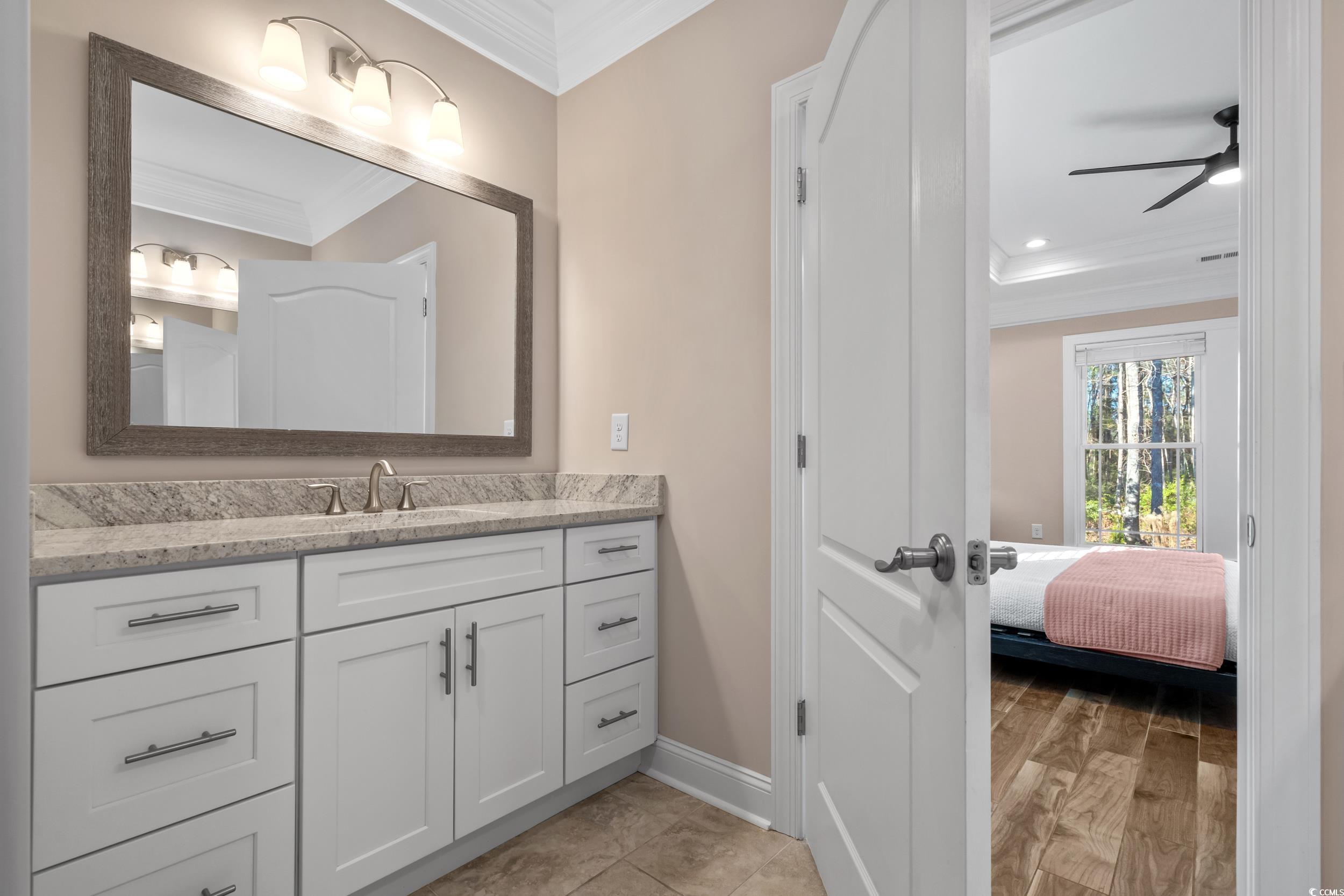 3021 Moss Bridge Lane Myrtle Beach, SC 29579 - Photo 23 of 40 Ensuite bathroom featuring ornamental molding, vanity, and ceiling fan