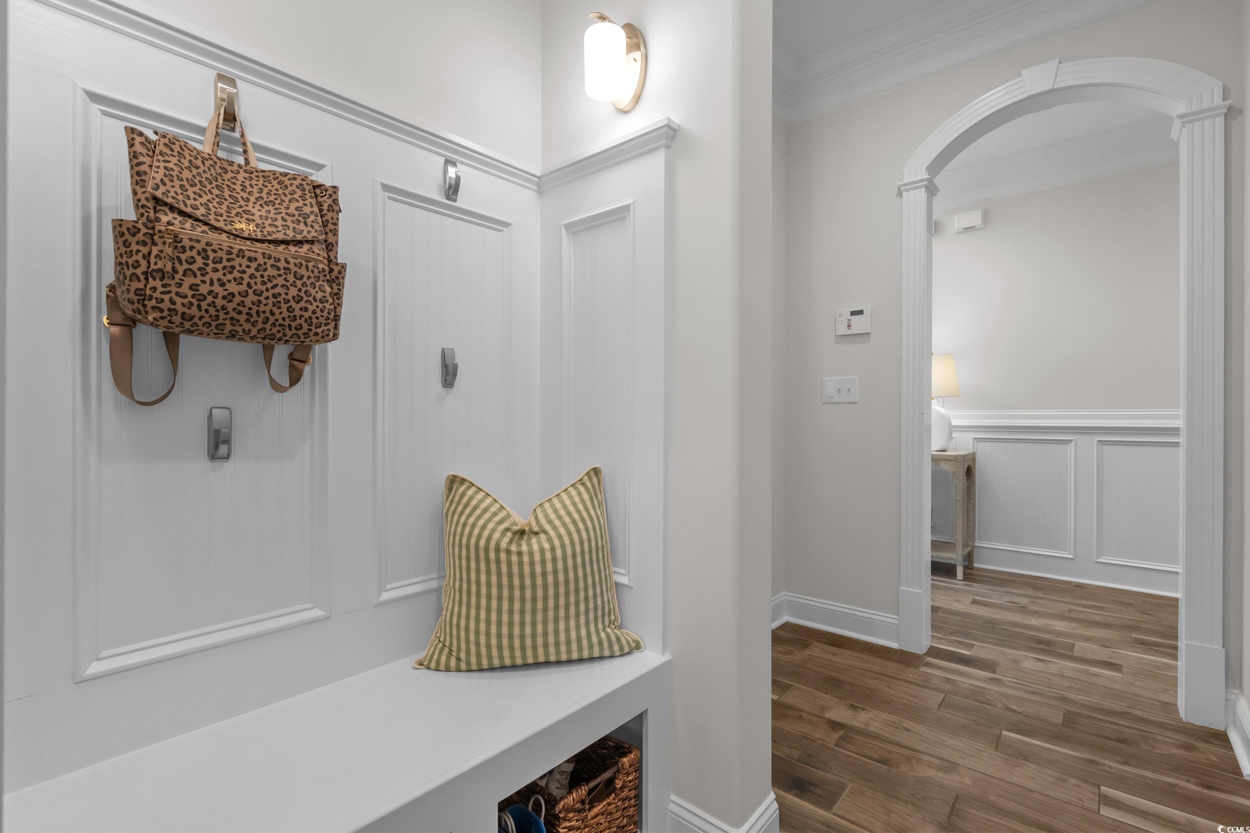 3021 Moss Bridge Lane Myrtle Beach, SC 29579 - Photo 27 of 40 Mudroom featuring a decorative wall, arched walkways, dark wood-type flooring, a wainscoted wall, and ornamental molding