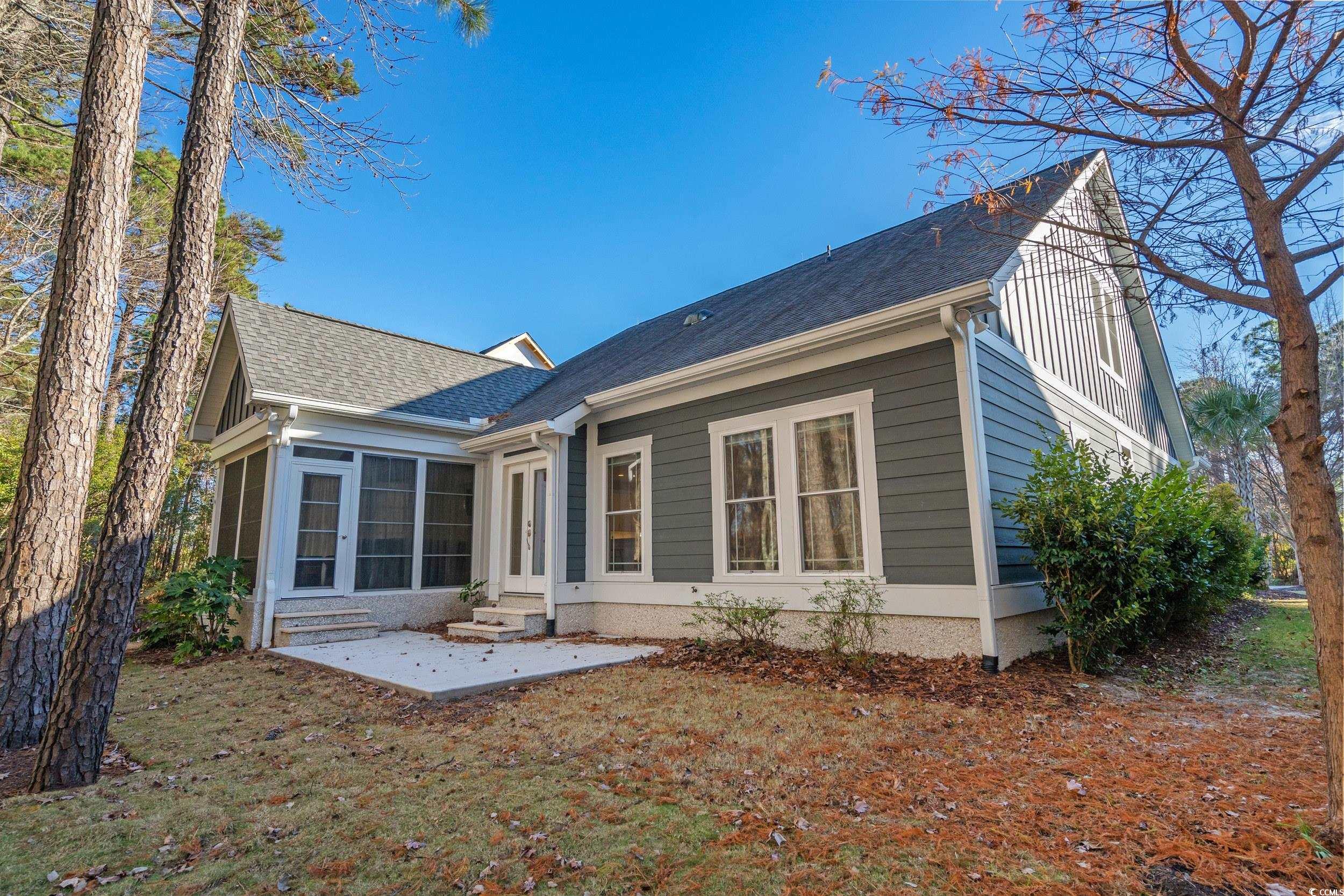 3021 Moss Bridge Lane Myrtle Beach, SC 29579 - Photo 34 of 40 Back of house with entry steps, a sunroom, a patio, roof with shingles, and board and batten siding