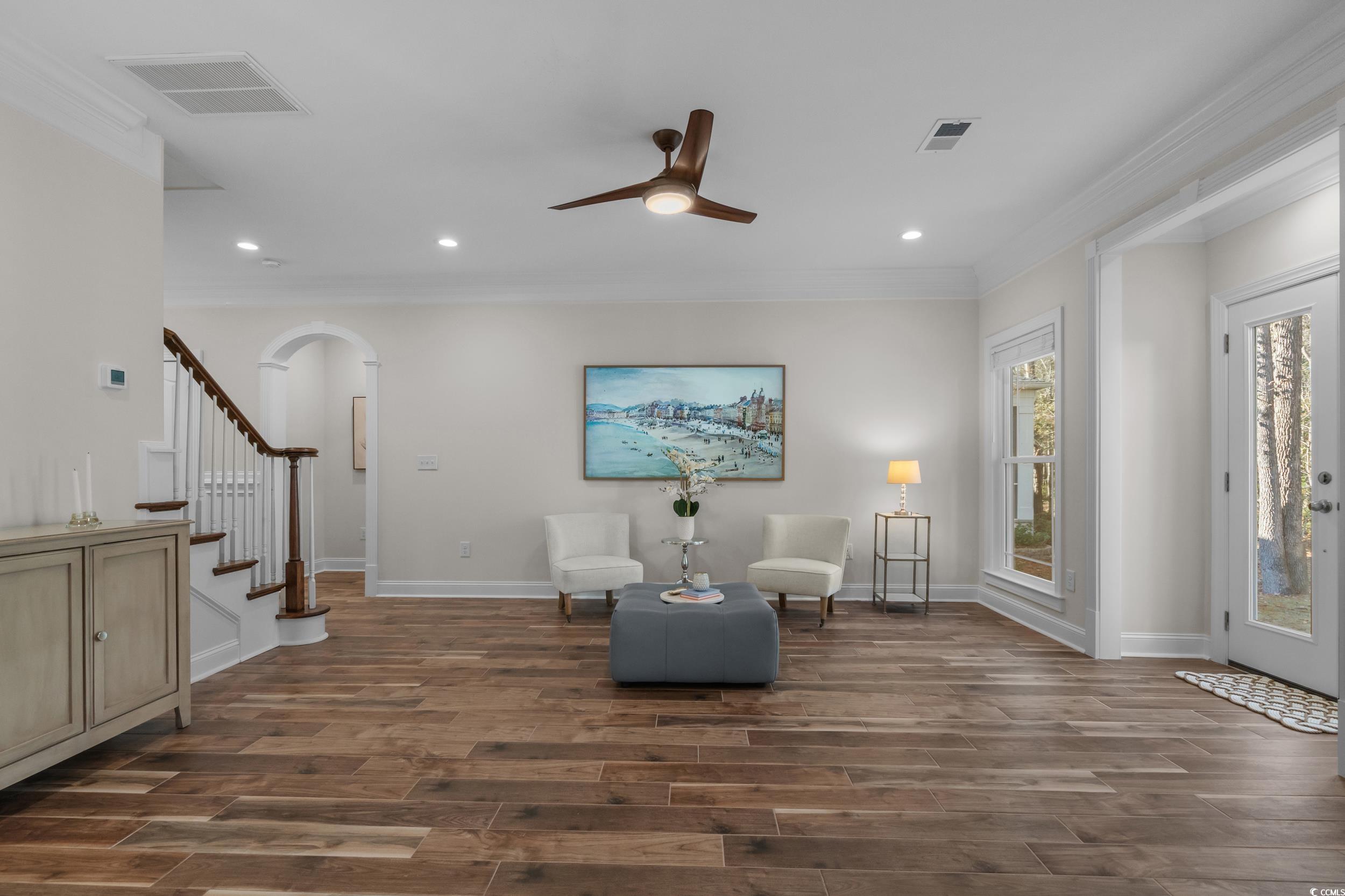 3021 Moss Bridge Lane Myrtle Beach, SC 29579 - Photo 9 of 40 Living area featuring ornamental molding, ceiling fan, arched walkways, recessed lighting, and dark wood-type flooring