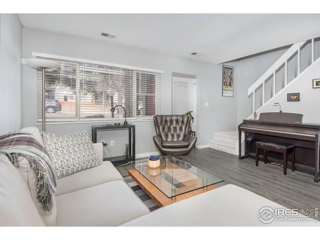 a living room with furniture and a piano