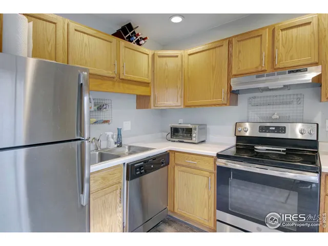 a kitchen with a refrigerator sink and cabinets