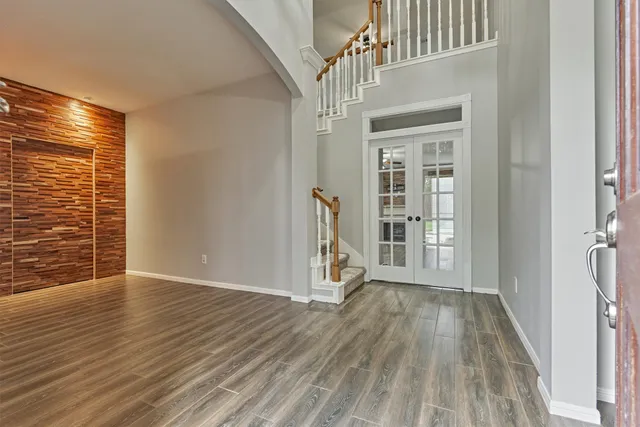 a view of an entryway with wooden floor