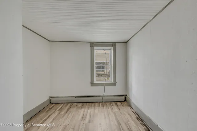 a view of a livingroom with wooden floor and staircase