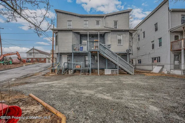 a view of a house with wooden deck