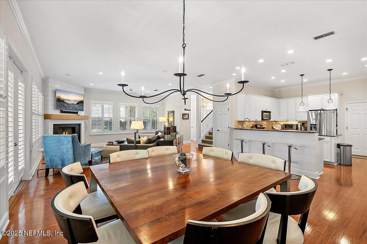 321 Fifth Street Atlantic Beach, FL 32233 - Photo 13 of 33 a kitchen with kitchen island stainless steel appliances a dining table chairs and a sink