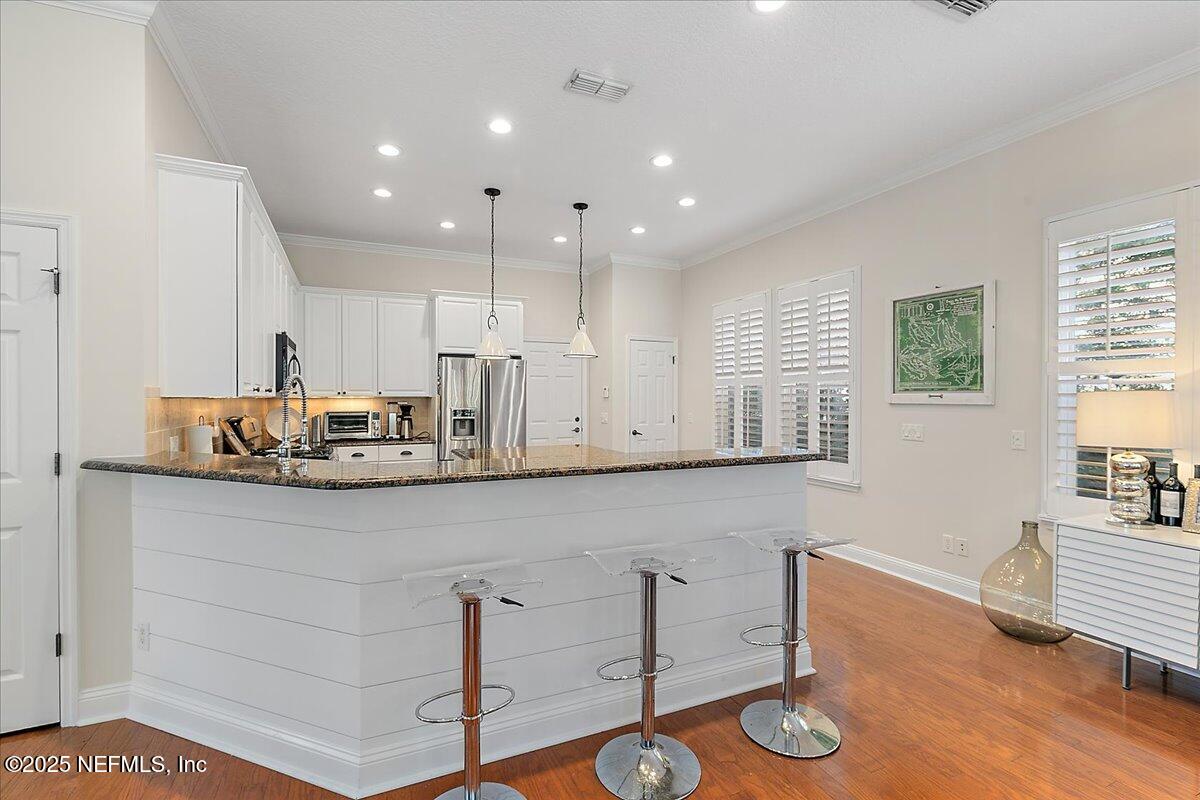321 Fifth Street Atlantic Beach, FL 32233 - Photo 15 of 33 a kitchen with a sink cabinets and wooden floor