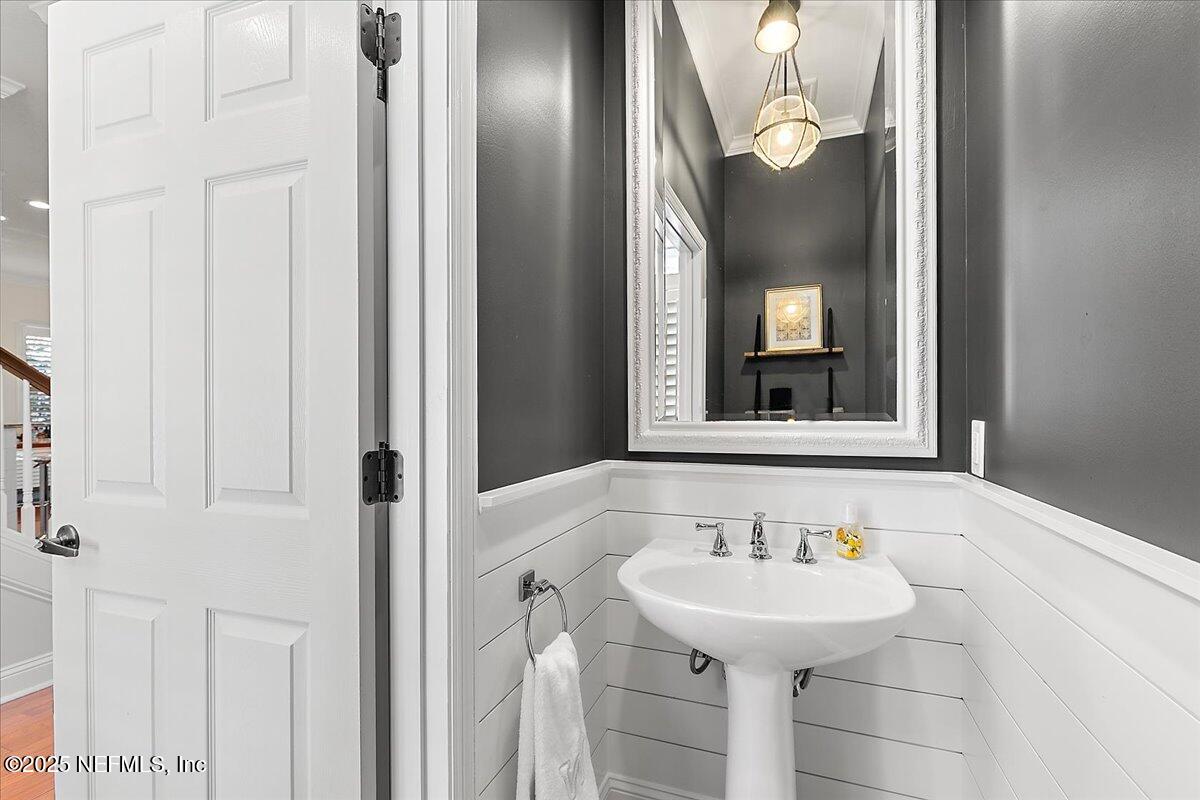 321 Fifth Street Atlantic Beach, FL 32233 - Photo 16 of 33 a bathroom with a sink and a mirror