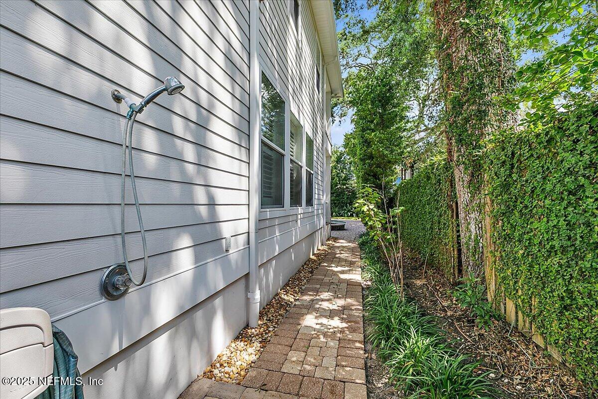 321 Fifth Street Atlantic Beach, FL 32233 - Photo 30 of 33 a view of a pathway with a wrought fence