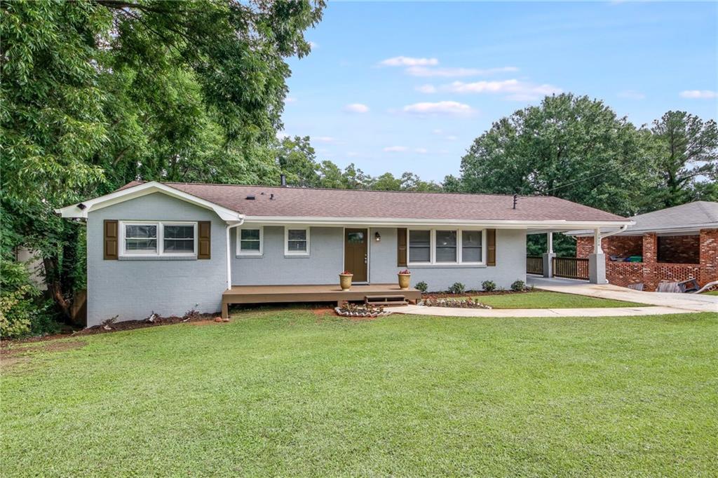 2920 Gena Drive Decatur, GA 30032 - Photo 1 of 1 a front view of a house with a garden and trees