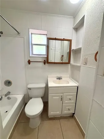 a bathroom with a sink toilet and tub
