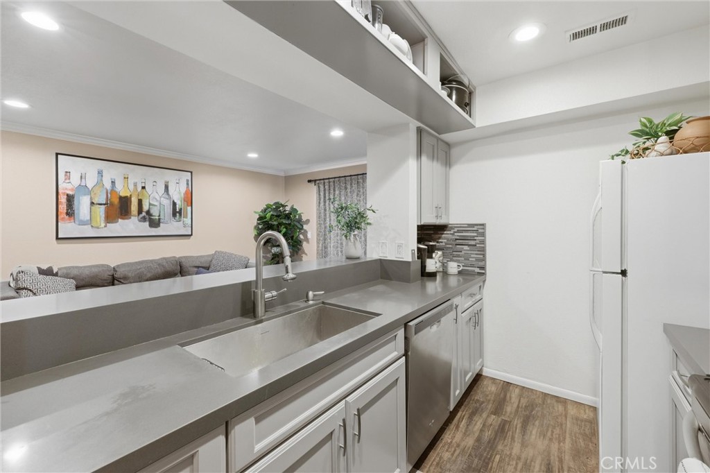 10655 Lemon Avenue Rancho Cucamonga, CA 91737 - Photo 1 of 1 a kitchen with a sink and a refrigerator