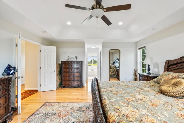a bedroom with a bed closet and flat screen tv