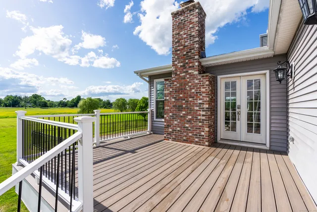 a view of a balcony with wooden floor and city view