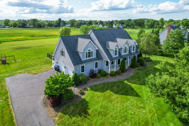 an aerial view of a house with big yard