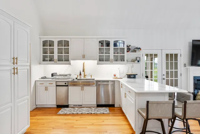 a kitchen with a sink stove and cabinets