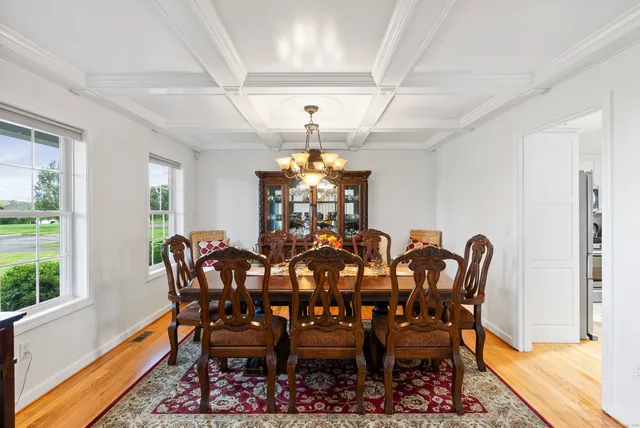 a view of a dining room with furniture and a window