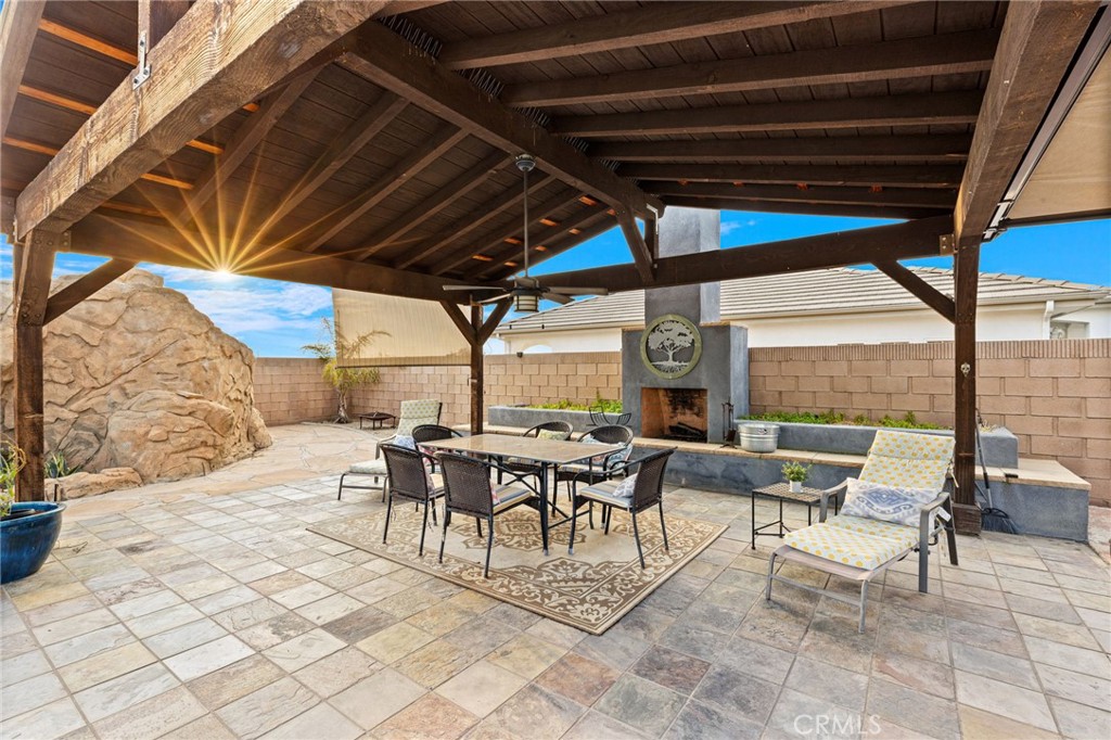 26487 Thacker Drive Hemet, CA 92544 - Photo 13 of 60 a view of a patio with table and chairs and potted plants