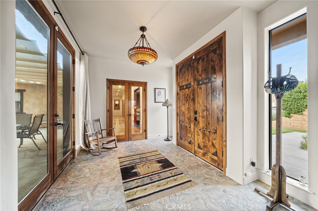26487 Thacker Drive Hemet, CA 92544 - Photo 24 of 60 a view of a hallway with wooden floor and a chandelier