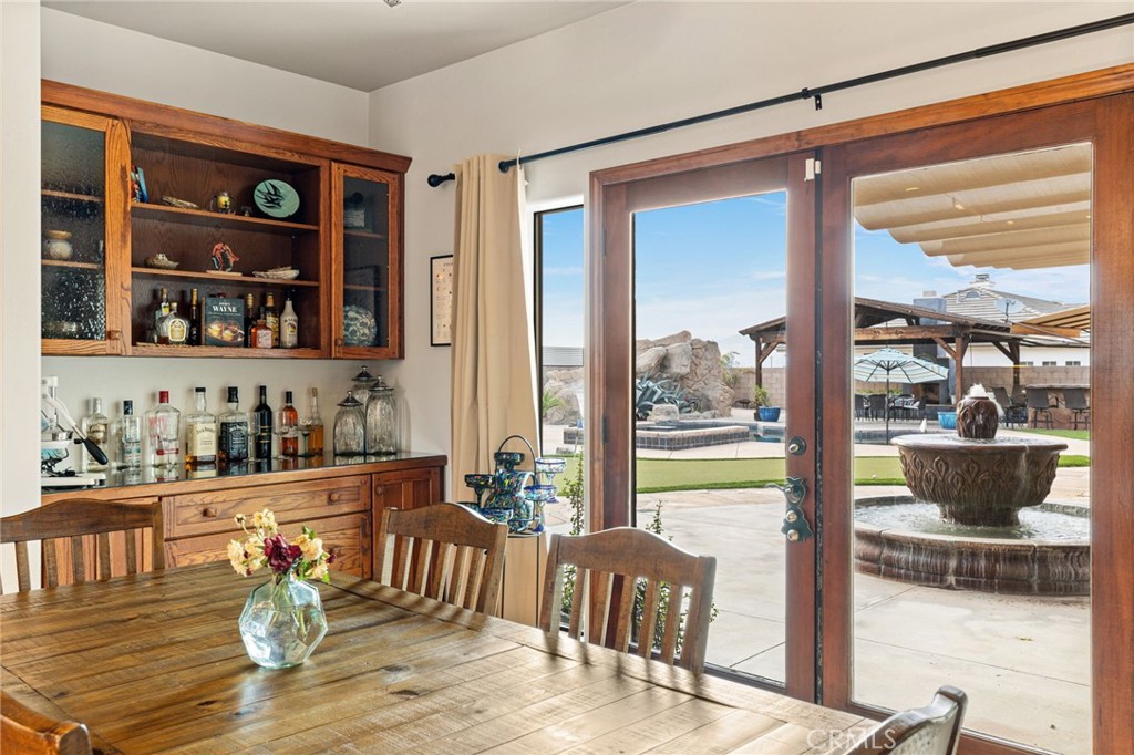 26487 Thacker Drive Hemet, CA 92544 - Photo 35 of 60 a dining room with furniture a chandelier and wooden floor