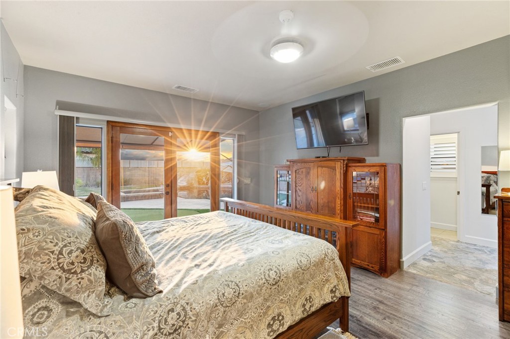 26487 Thacker Drive Hemet, CA 92544 - Photo 40 of 60 a bedroom with a bed and wooden floor