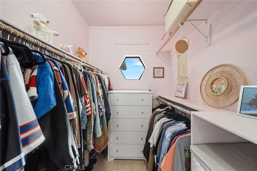 26487 Thacker Drive Hemet, CA 92544 - Photo 43 of 60 a view of walk in closet with clothes and shoes
